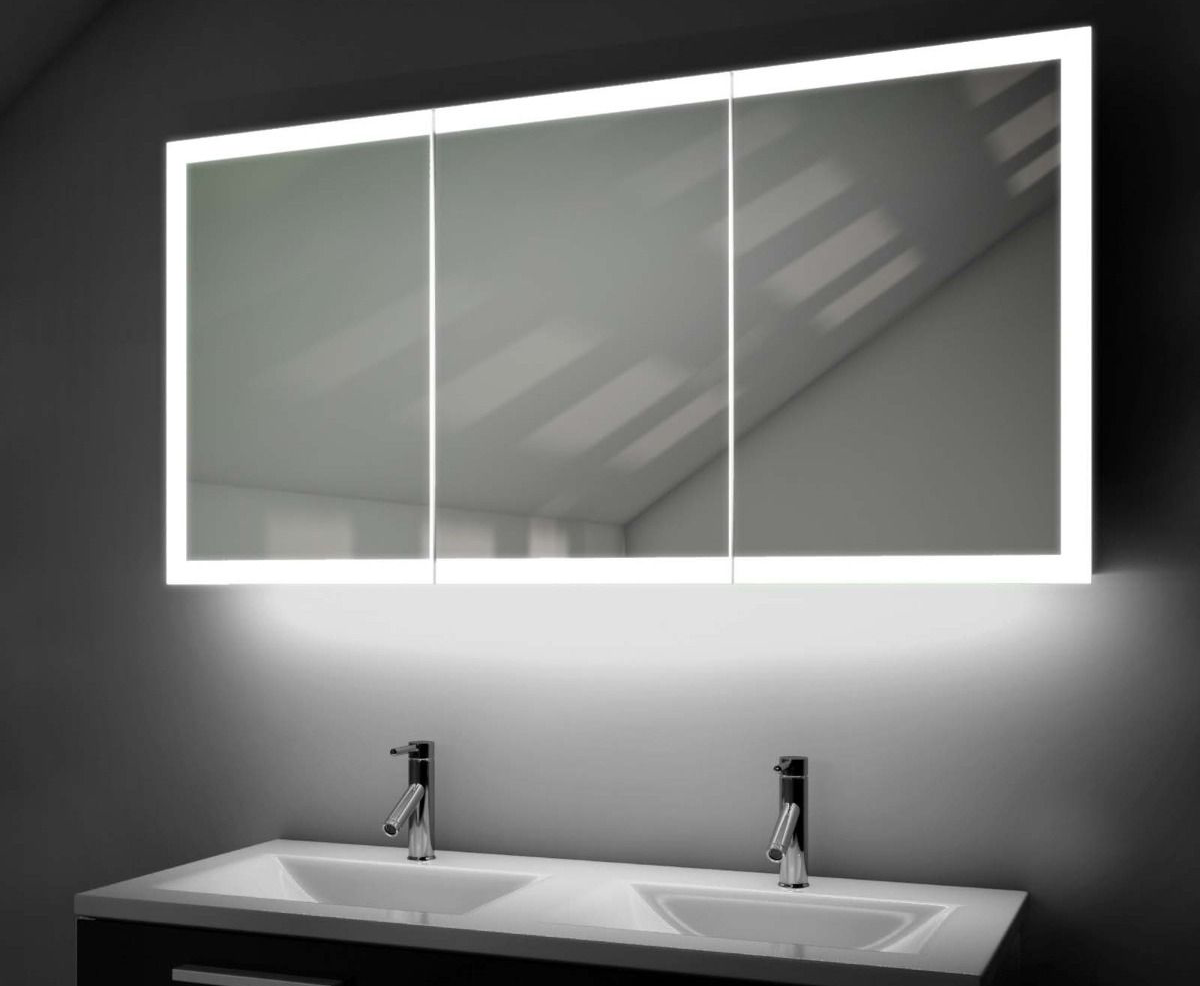 Lit bathroom medicine cabinet above a double sink with faucets.