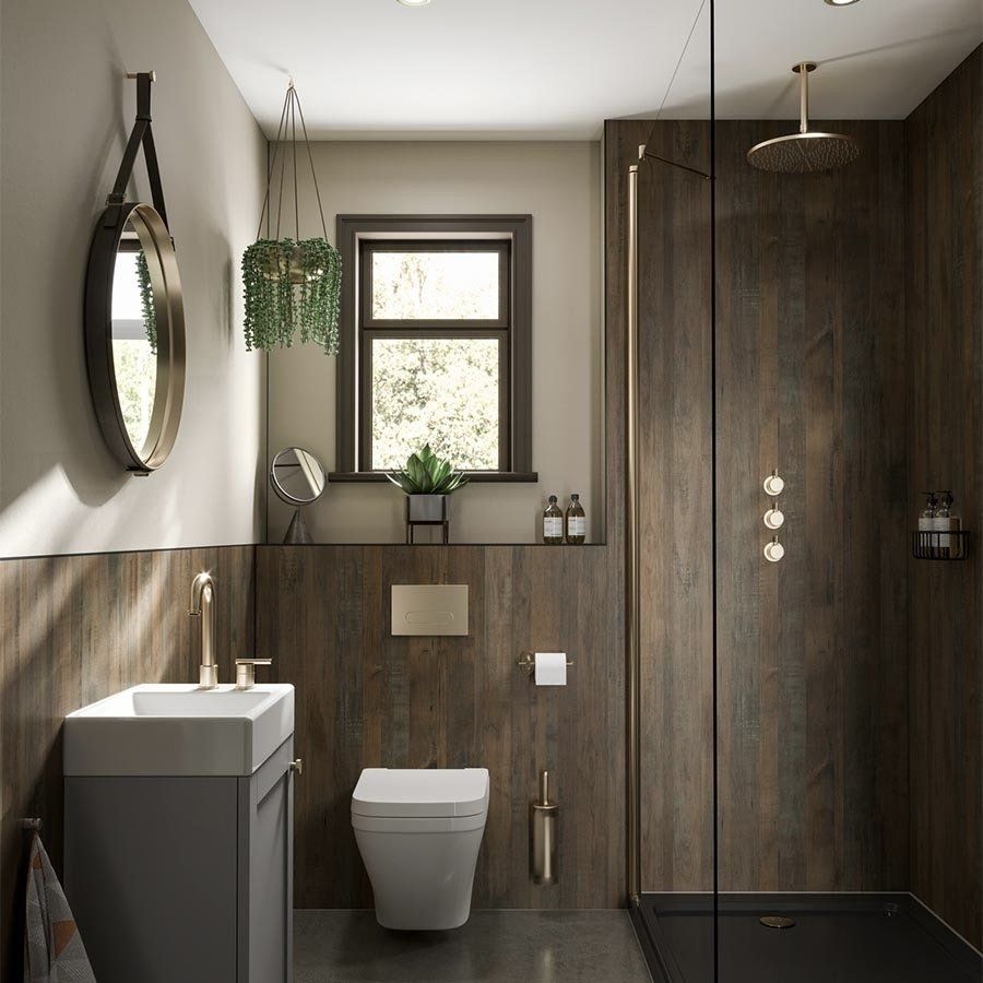 Bathroom with dark wood paneling, gray vanity, gold fixtures, and a shower with a glass door.