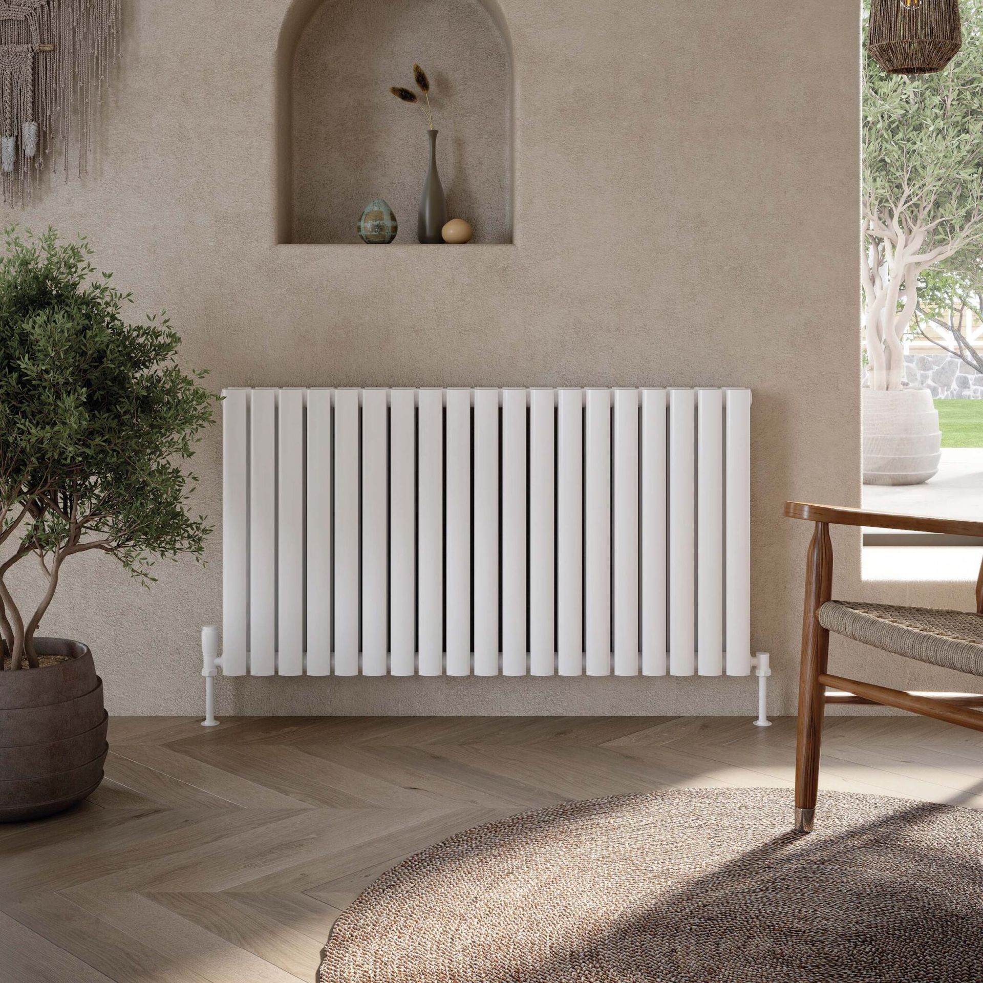 White radiator against a textured wall with plant and arched niche, sunny interior.