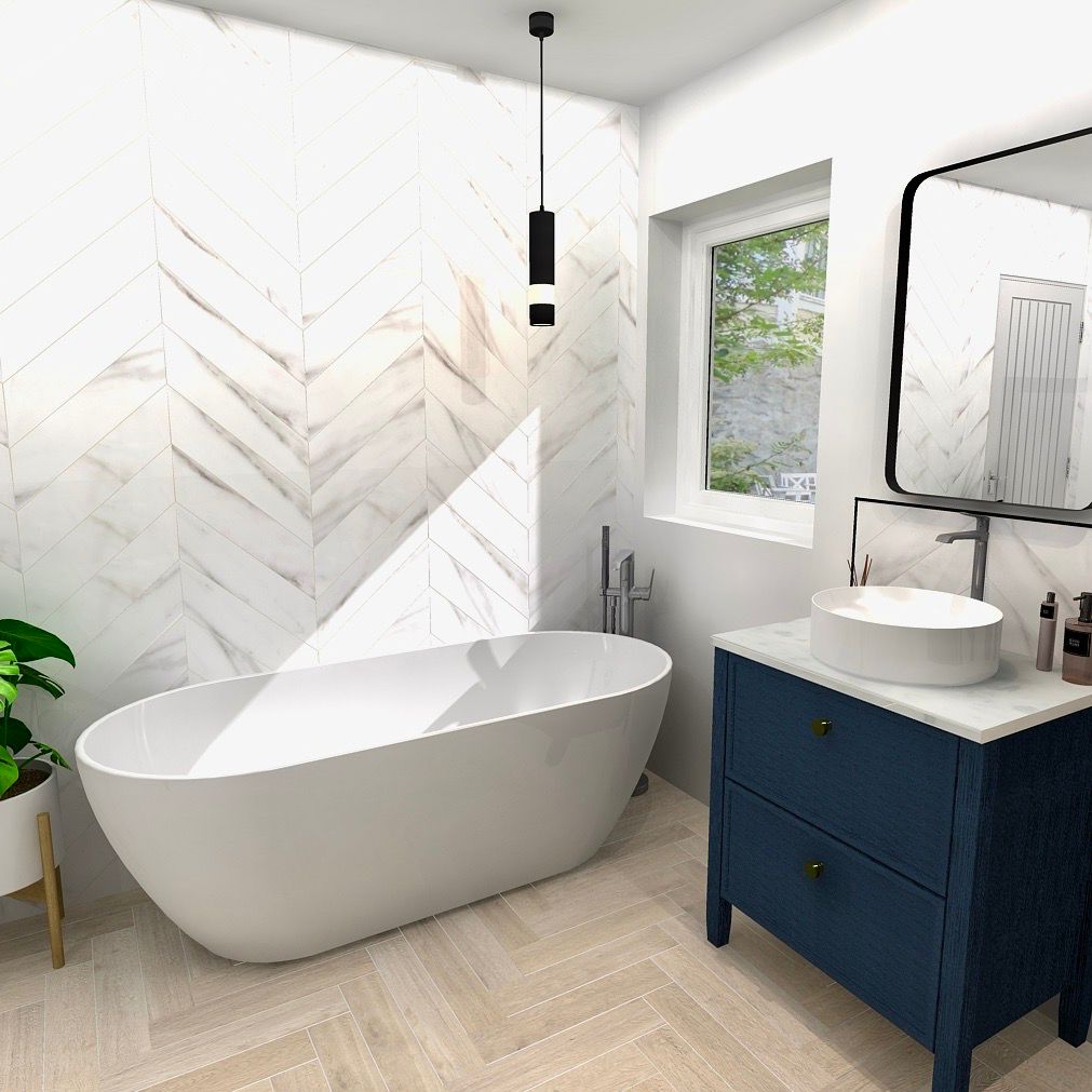 Modern bathroom with a bathtub, vanity, and herringbone tile.