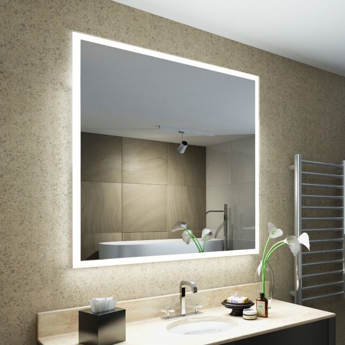 Square bathroom mirror with integrated LED lighting, reflecting a modern bathroom with a sink, bathtub, and towel warmer.