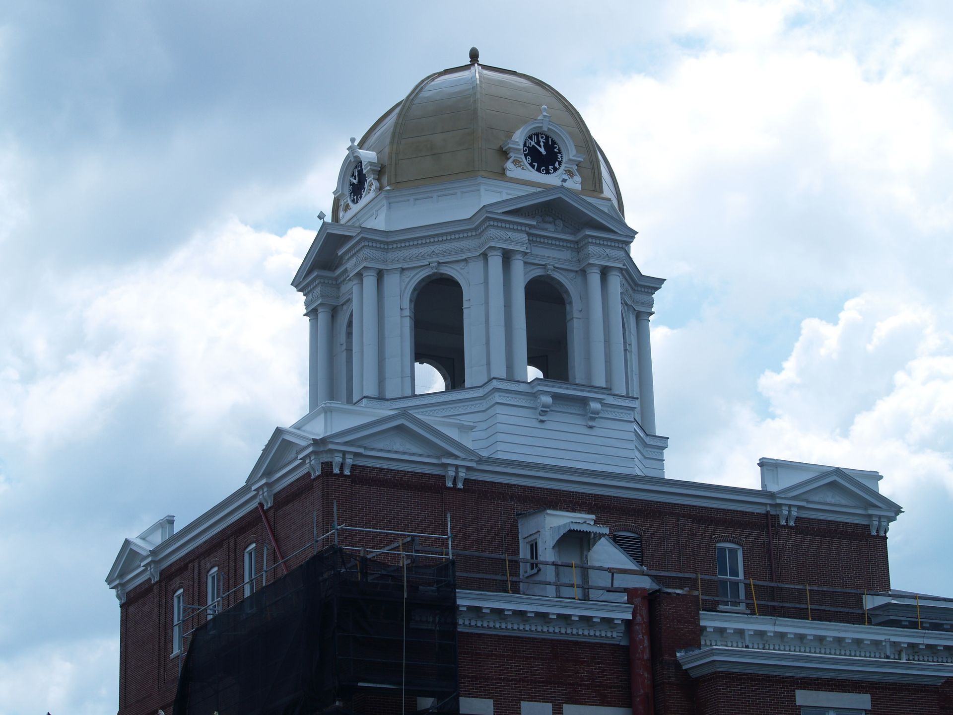 A large metal roof with a blue sky in the background