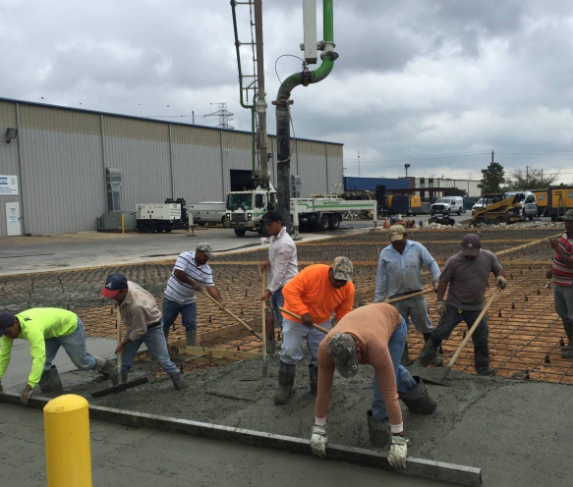 “Crew placing fresh concrete from a pump truck while preparing a large commercial slab for a concrete contractor in Oro Valley, AZ”