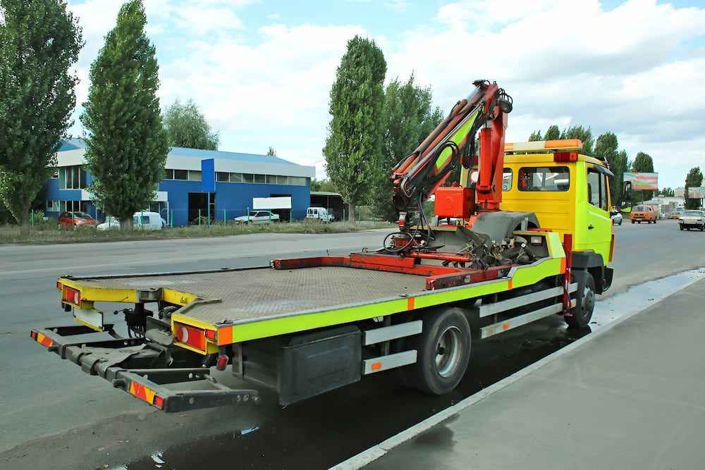A Yellow Tow Truck With A Crane — Ollies Towing & Shipping Container Sales in Blackbutt, QLD