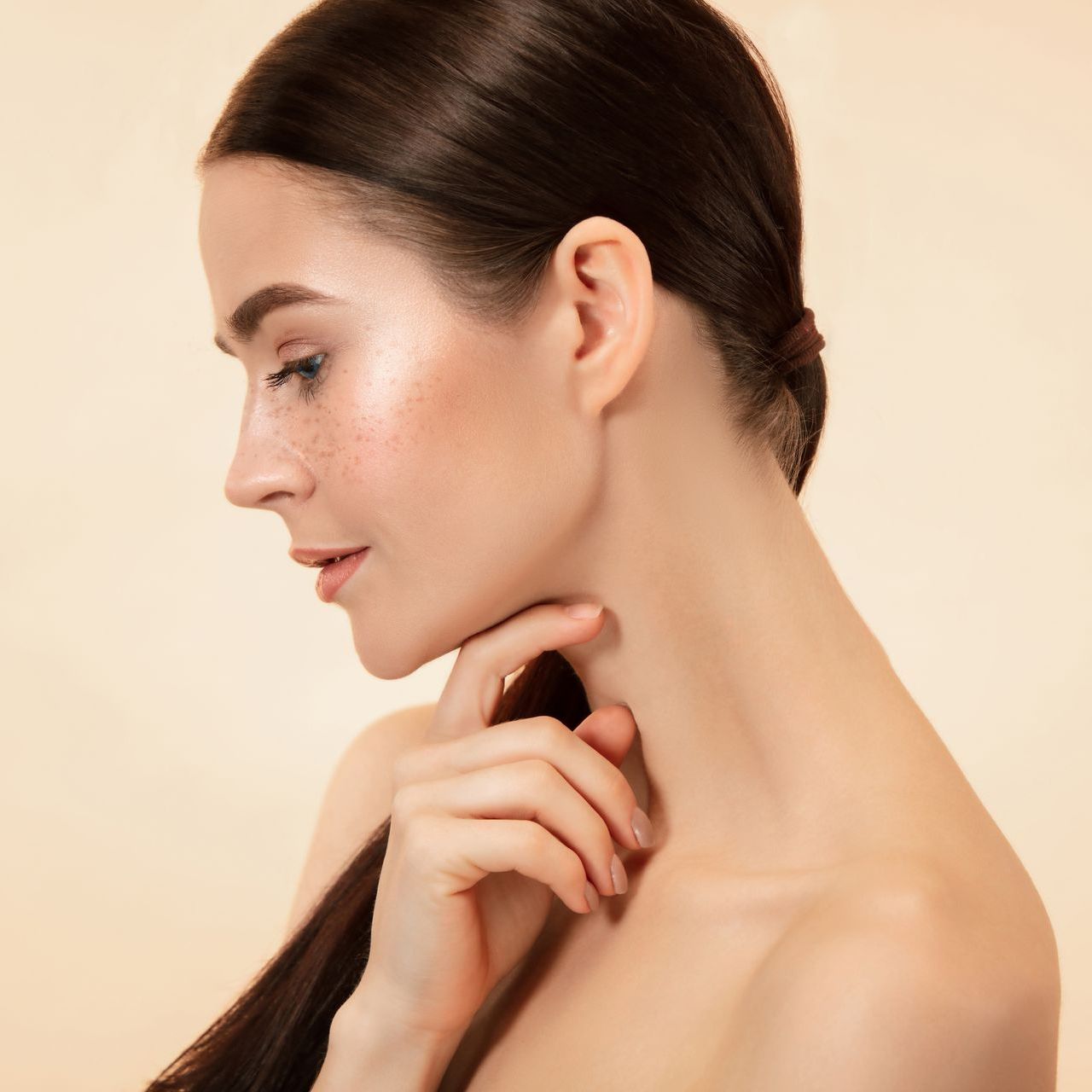Woman touches her neck with her hand at ERA Wellness Spa
