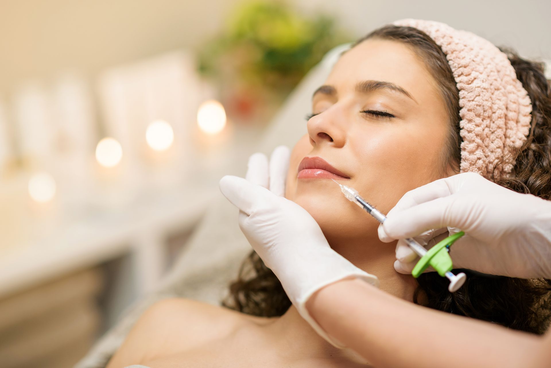 a woman is getting a botox injection in her face at ERA Wellness Spa in Georgetown, KY