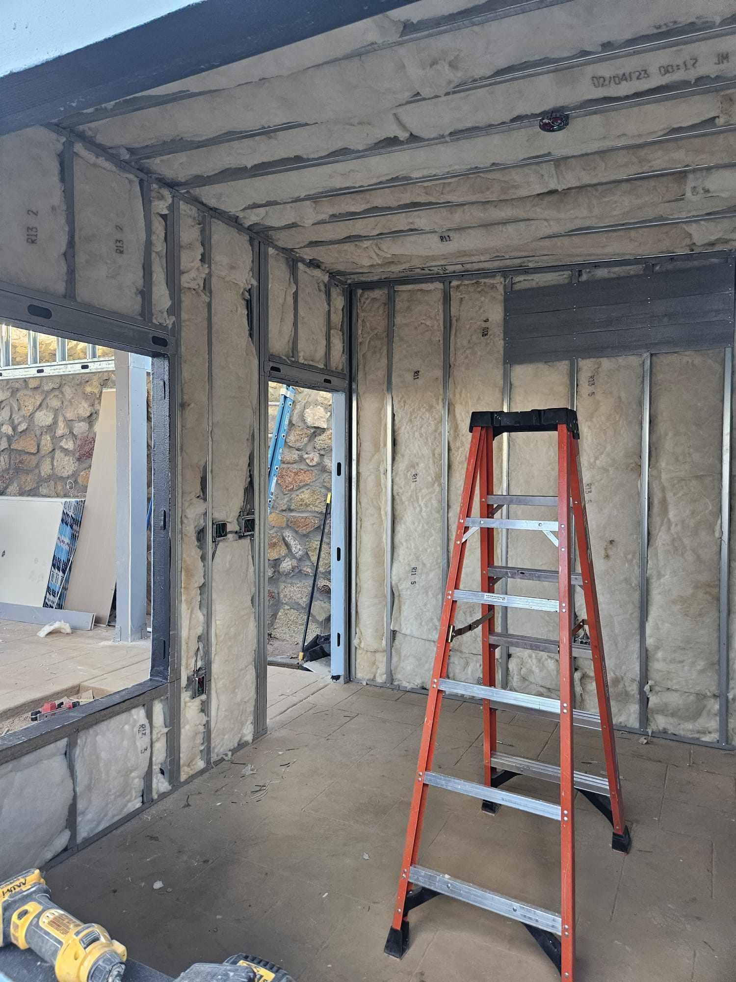 A ladder is sitting in the middle of a room.