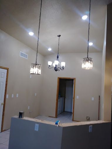 A room with a chandelier hanging from the ceiling