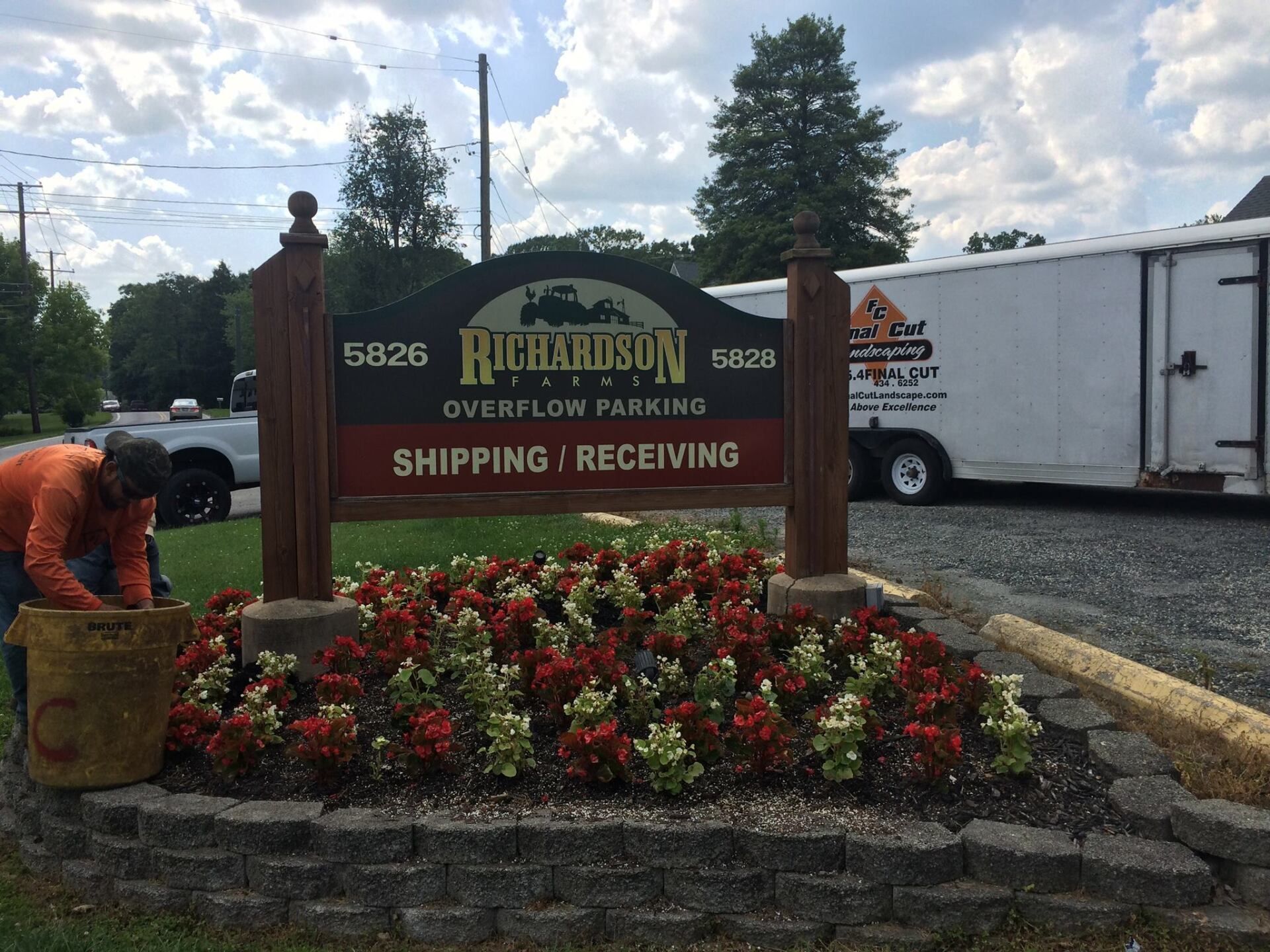 Sign for Richardson with overflow parking, shipping/receiving, being landscaped, with trailer in the background.