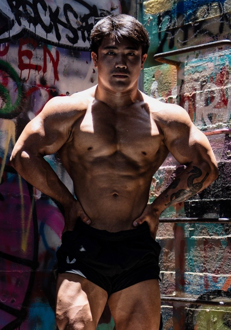 Manni kumar  i is using a machine in a gym with a sign that says fit the next