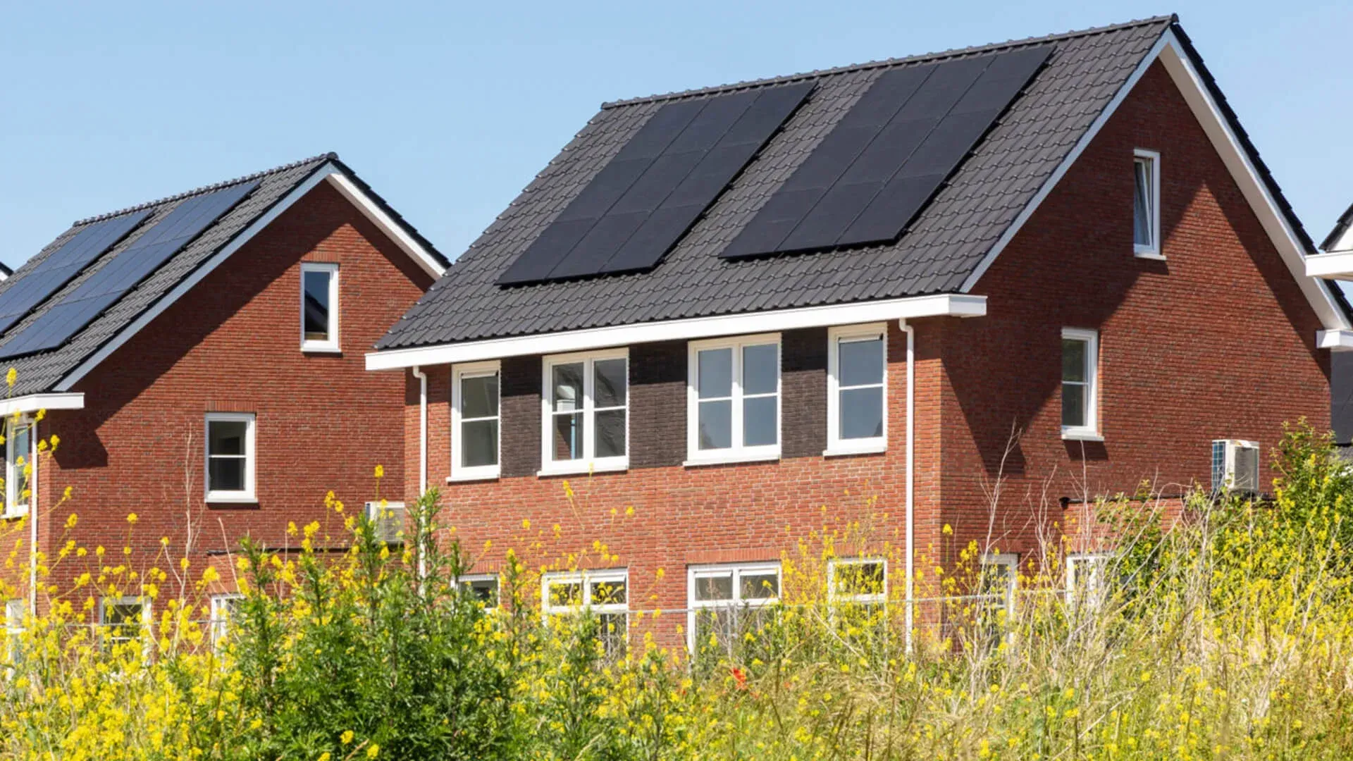 A row of brick houses with solar panels on the roofs