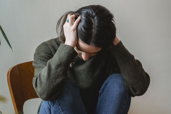 An image of a woman sitting alone suffering anxiety at Imperial Psychiatric Services in DE