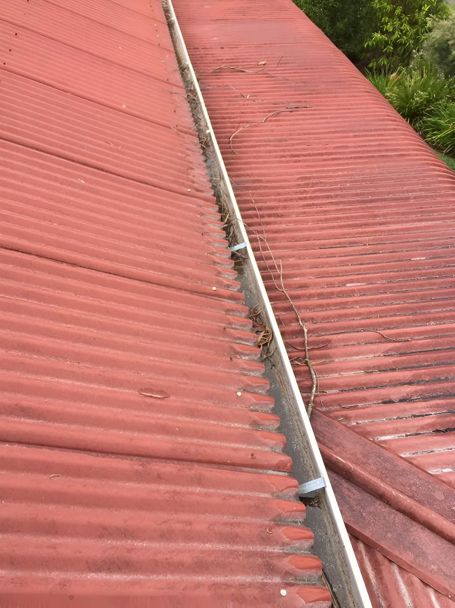 Close Up of a Red Roof With a Gutter on It — Hastings Services in Taree, NSW