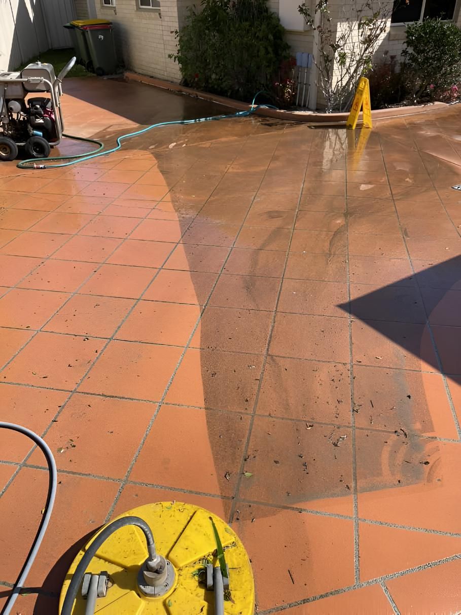 Yellow Hose is Being Used to Clean a Tiled Floor — Hastings Services in Port Macquarie, NSW