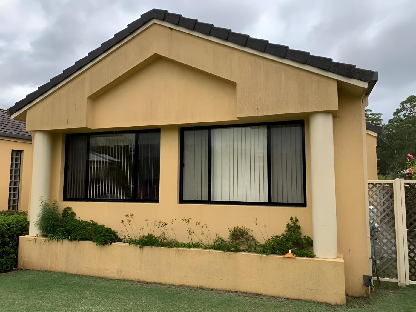 Yellow House Getting Clean Their Window — Hastings Services in Bonny Hills, NSW