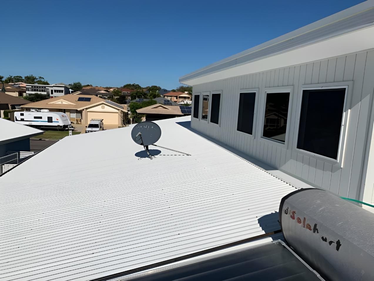 White Building With a Satellite Dish — Hastings Services in Port Macquarie, NSW