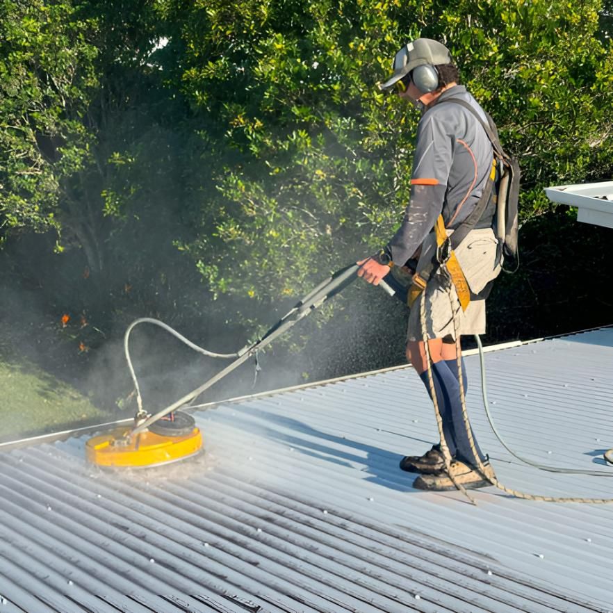 Man is Cleaning a Roof With a Machine — Hastings Services in Port Macquarie, NSW