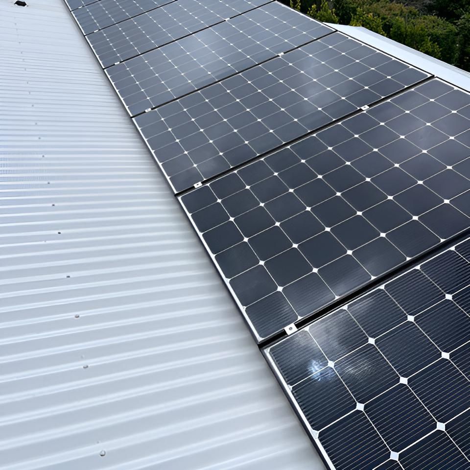 Row of Solar Panels on a White Roof — Hastings Services in Port Macquarie, NSW