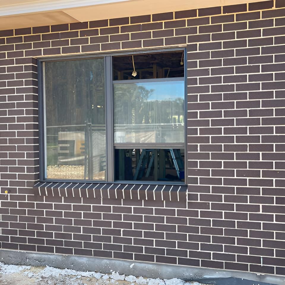 Brown Brick Wall With a Window on It — Hastings Services in Port Macquarie, NSW