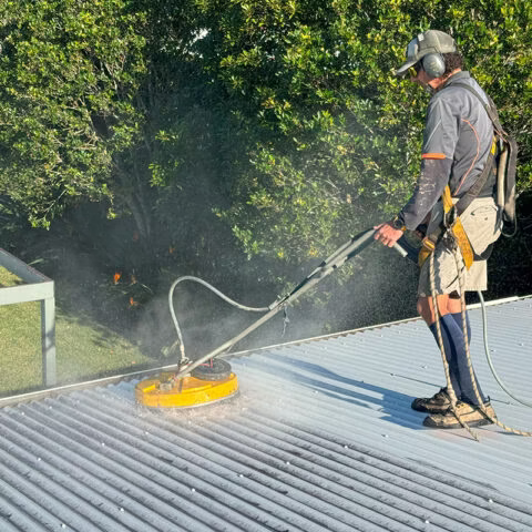Man deep cleaning the roof of a house  — Hastings Services in Port Macquarie, NSW