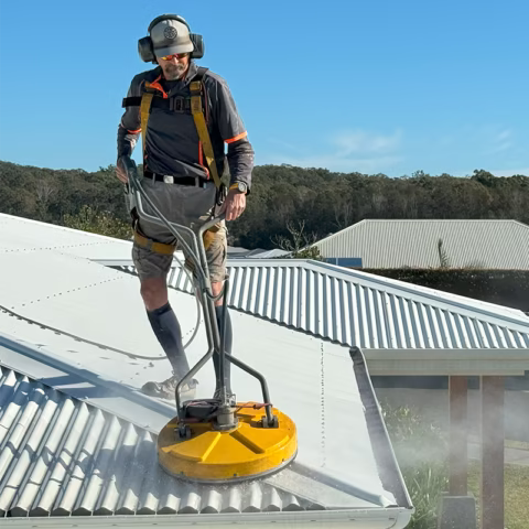 Man deep cleaning the roof of a house — Hastings Services in Port Macquarie, NSW