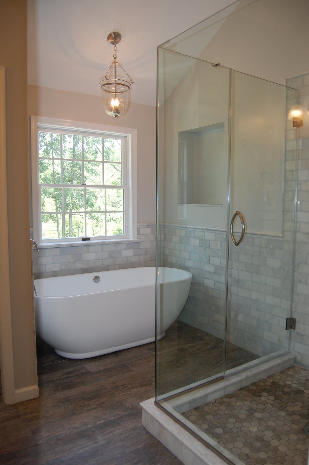A bathroom with a tub and a walk in shower.