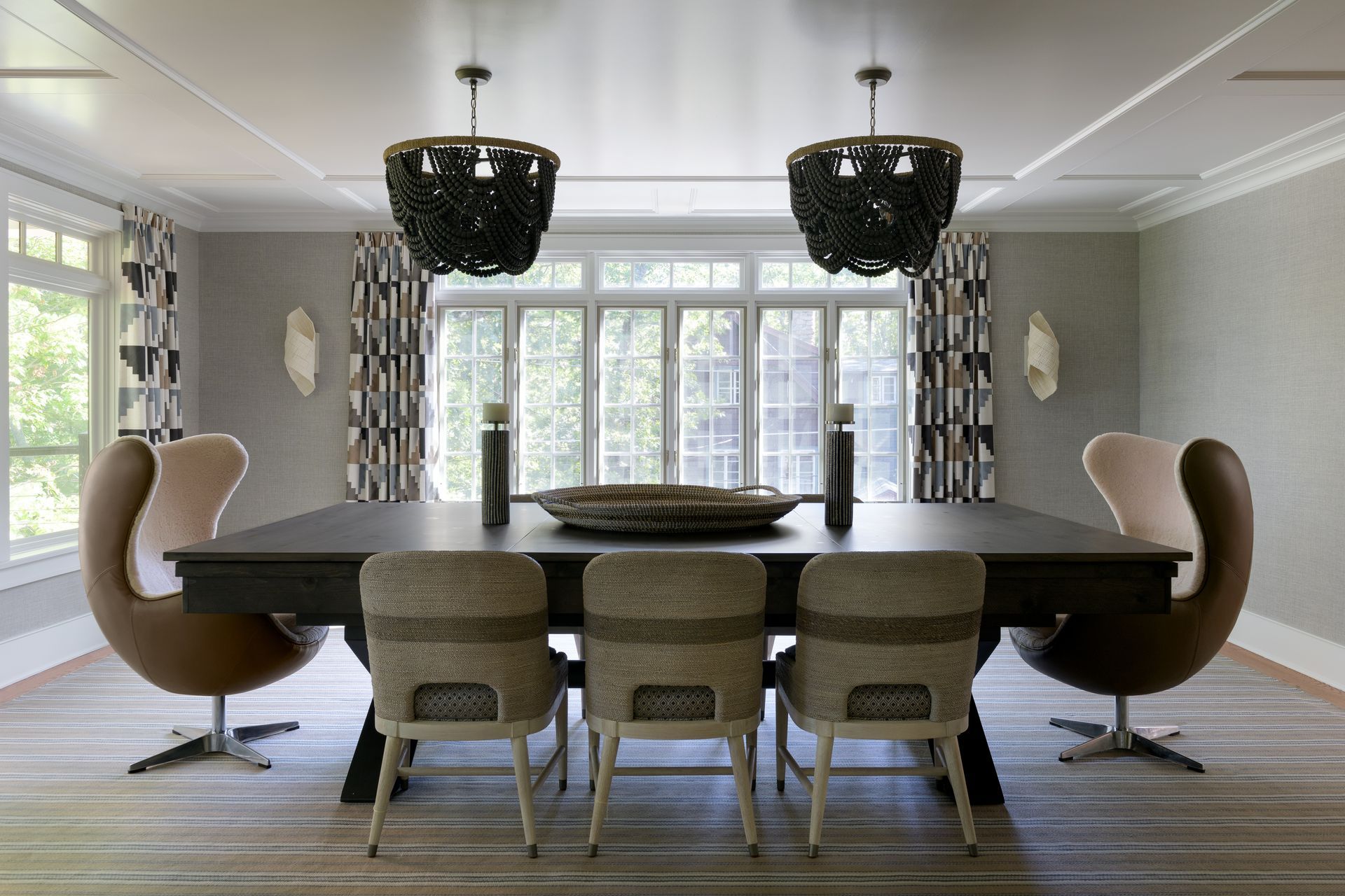 A dining room with a large table and chairs