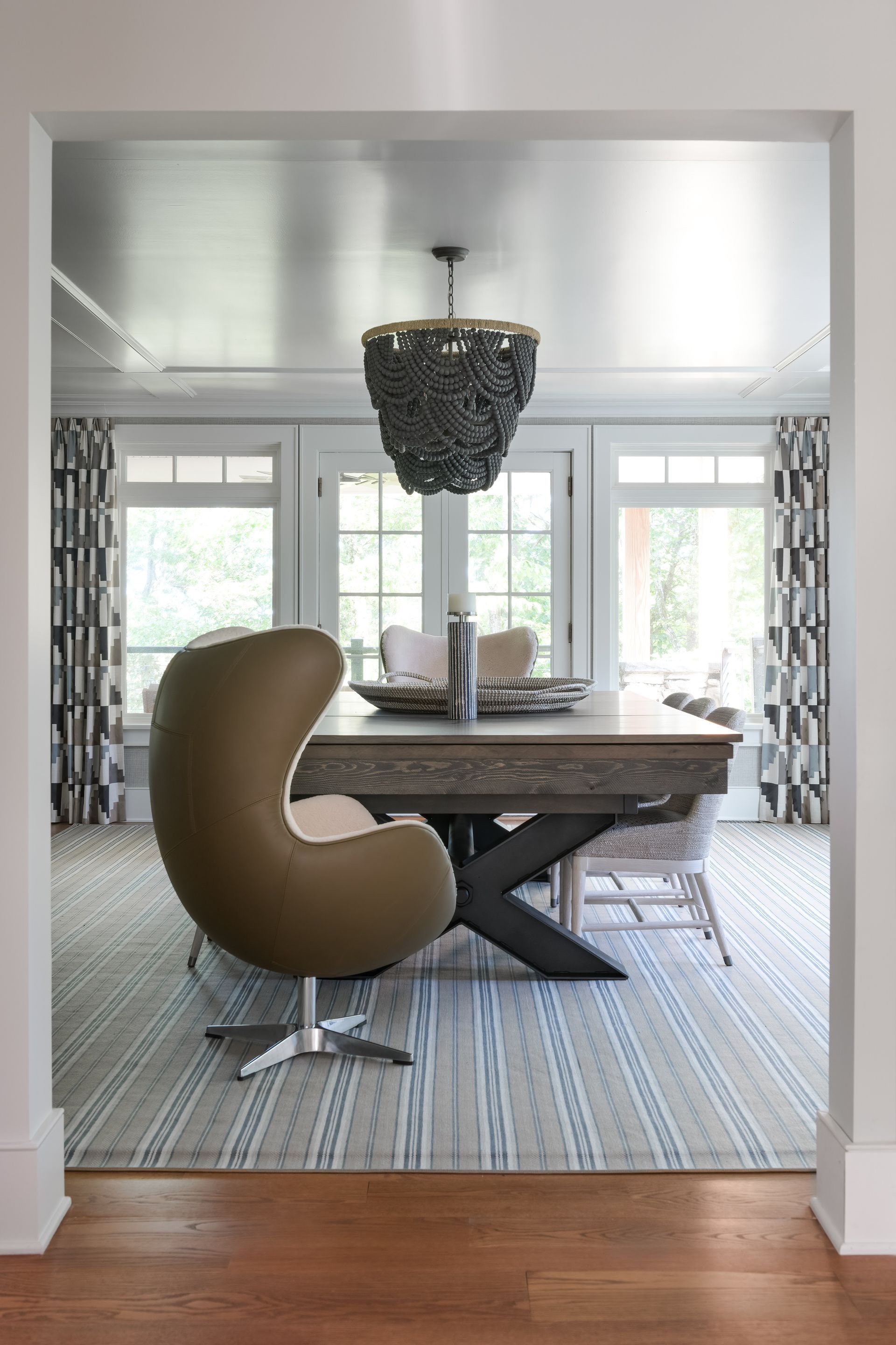 A dining room with a table and chairs and a chandelier.