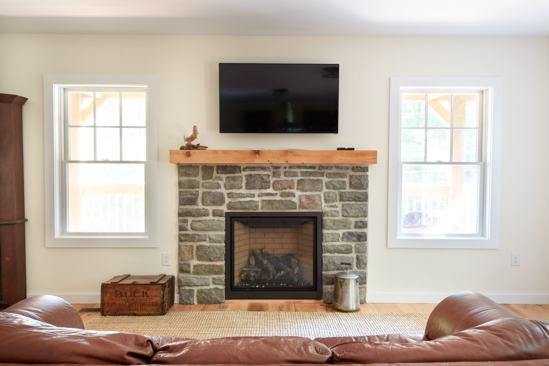 A living room with a fireplace and a flat screen tv.