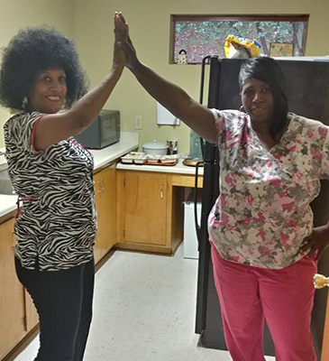 two caregivers doing high five