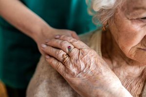 senior woman holding the hand of her caregiver senior woman holding the hand of her caregiver