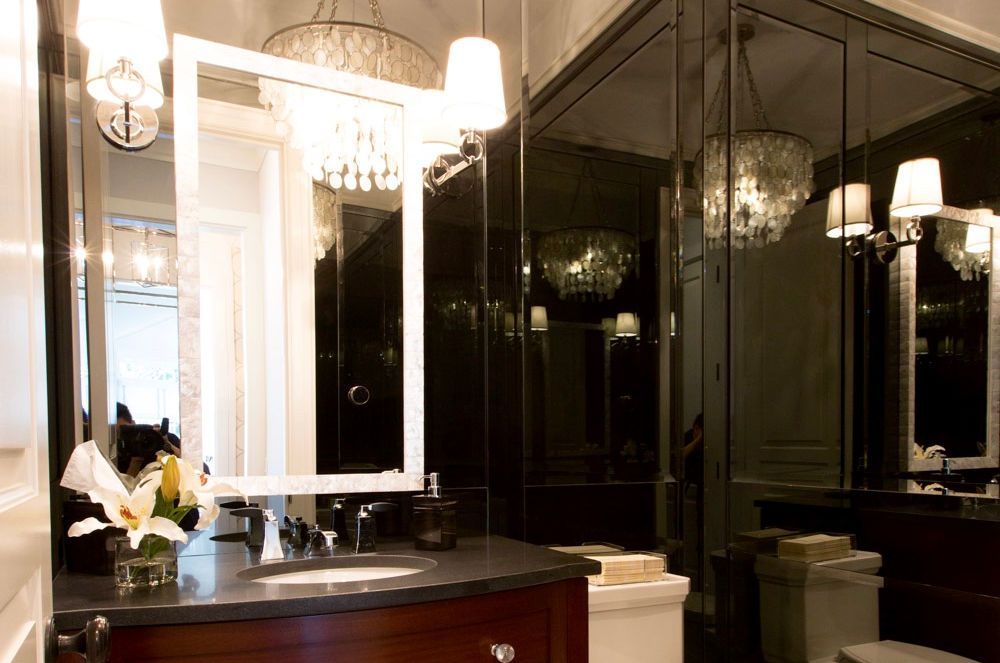 A bathroom with a sink a toilet and a mirror