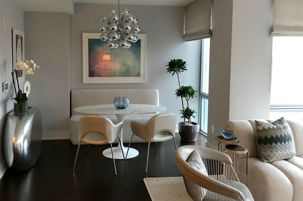 A living room with a dining table and chairs