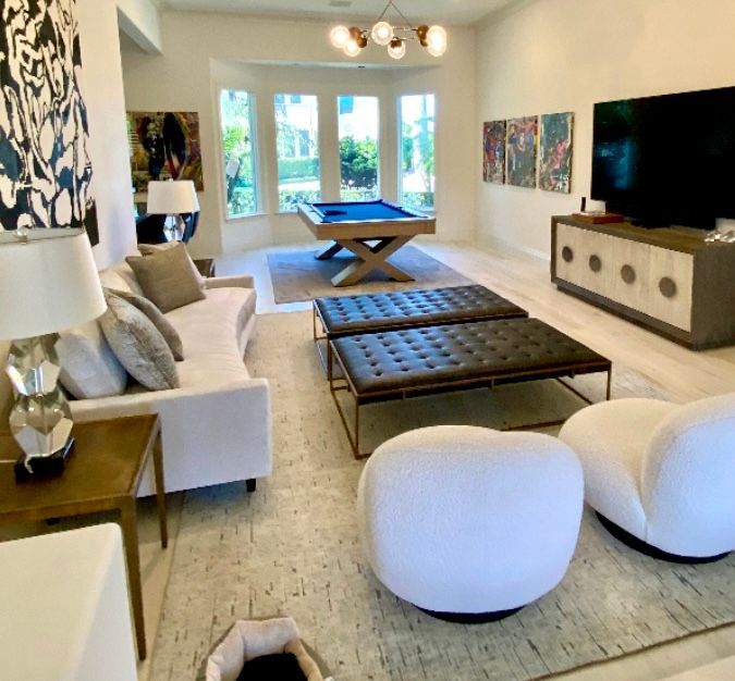 A living room with a pool table and a couch