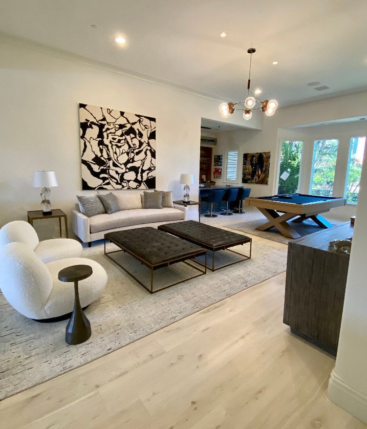A living room with a pool table and a couch