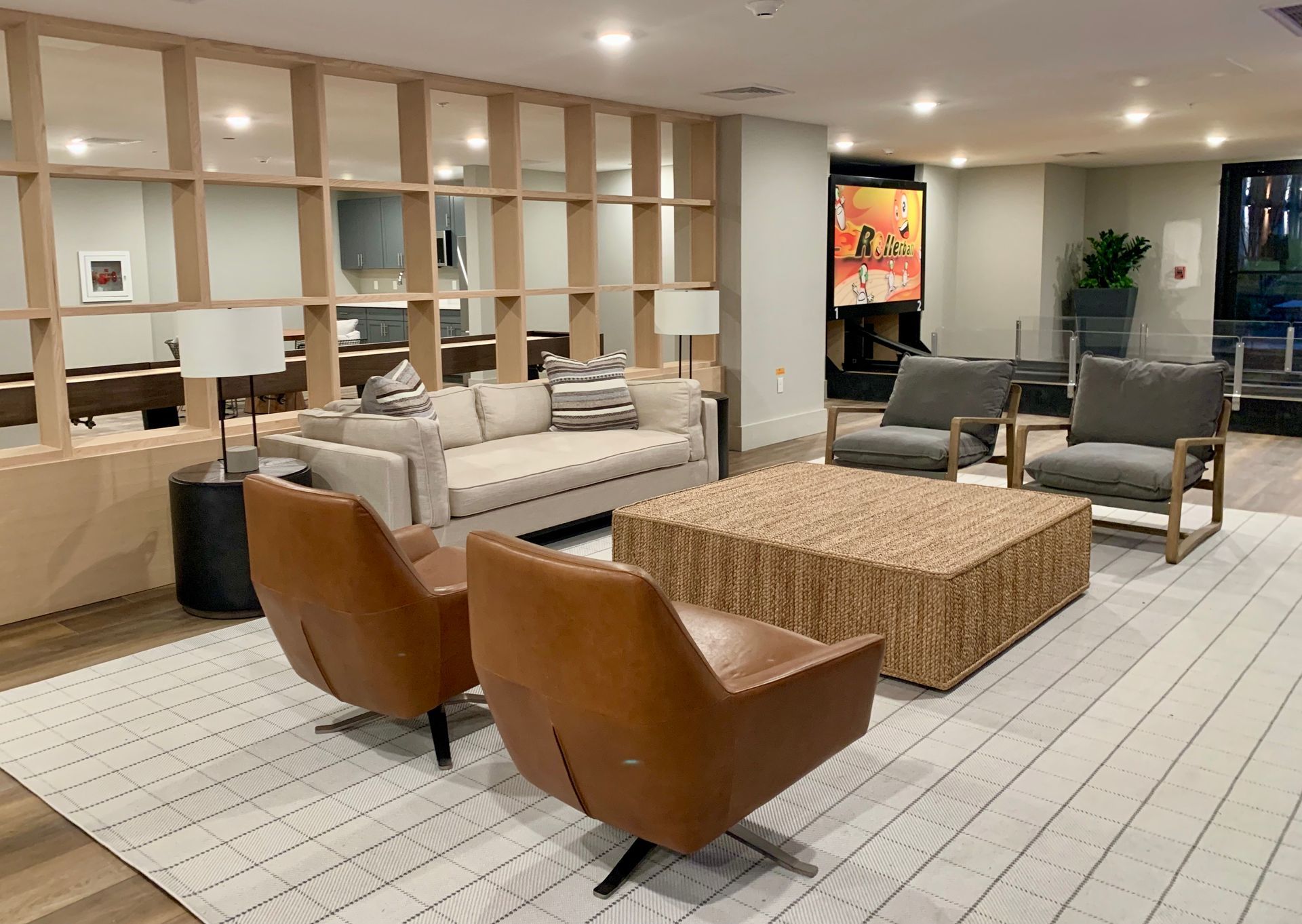 A living room with a couch , chairs , and a coffee table.