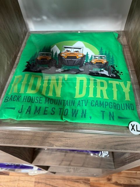 Green “Ridin’ Dirty” T-shirt with mountain ATV campground graphic and “Jamestown, TN” text in a box