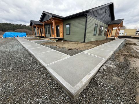 Two construction experts review the site blueprint onsite at a residential remodel