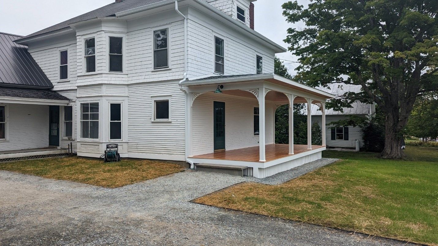 A home remodel featuring a covered porch built by Juggernaut Construction Company in Vermont