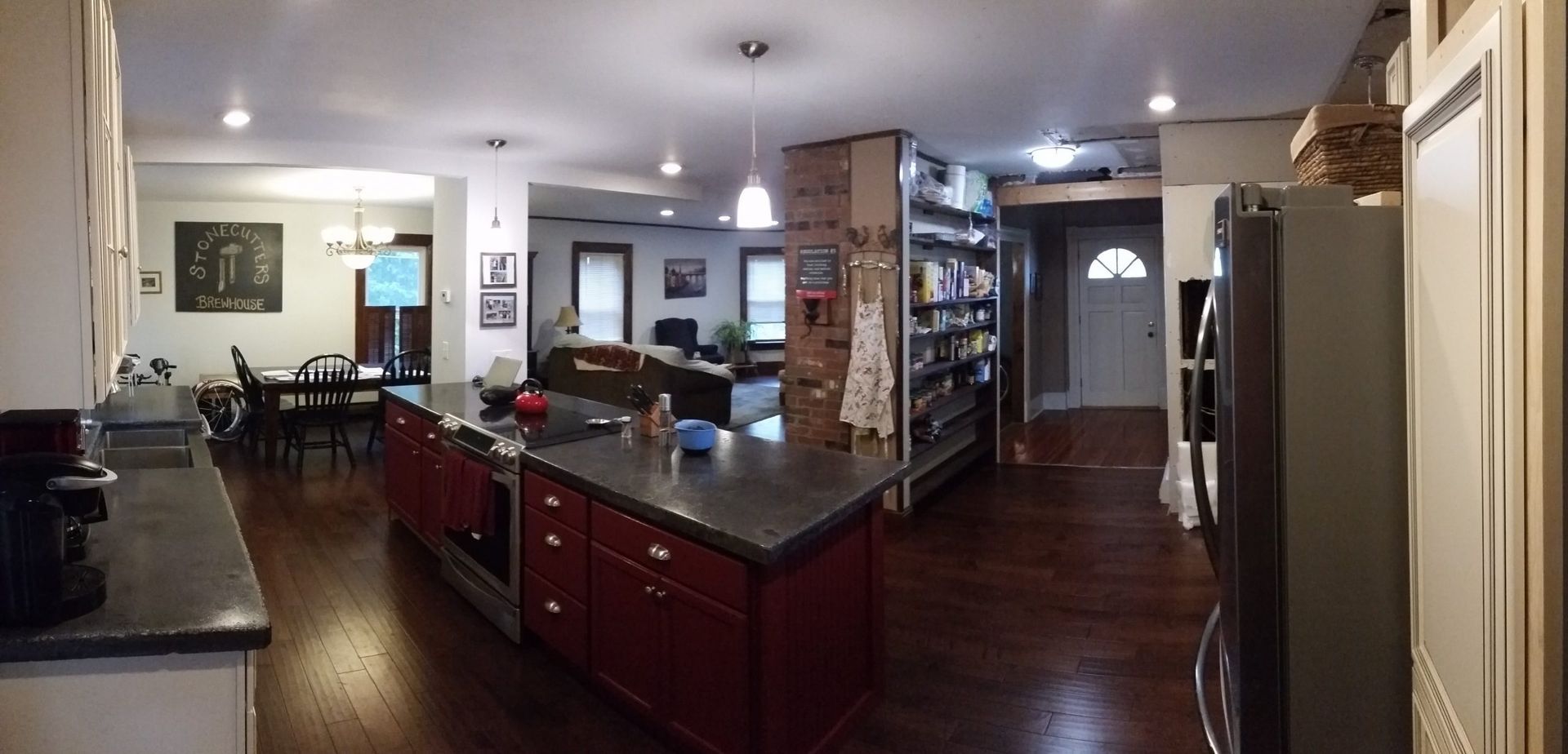 A beautiful kitchen remodel with cherry wood, cherry cabinets, and black granite counters by Juggernaut Construction Company