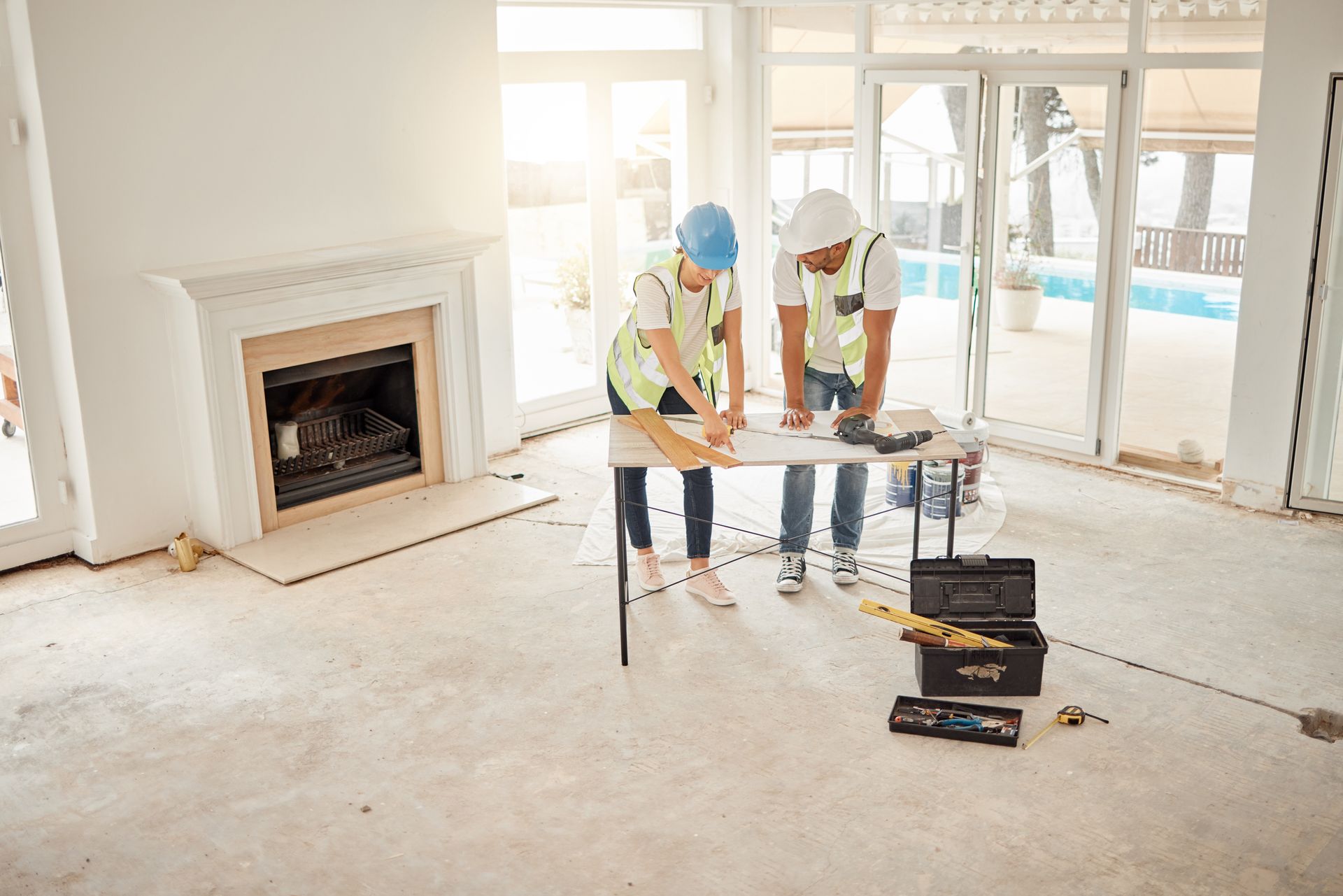 Contractors review site plans in the midst of a home remodel