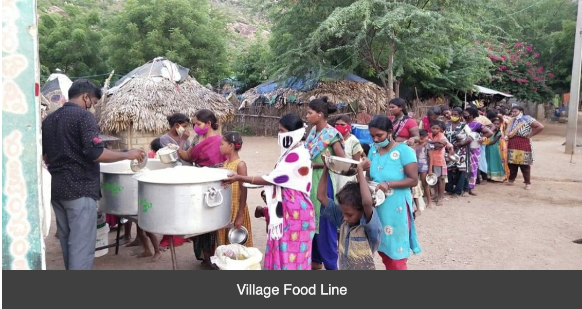 A group of people are standing in a line holding pots of food.