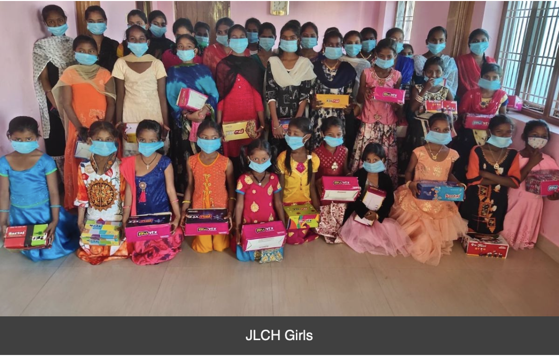 A group of children wearing face masks are posing for a picture.