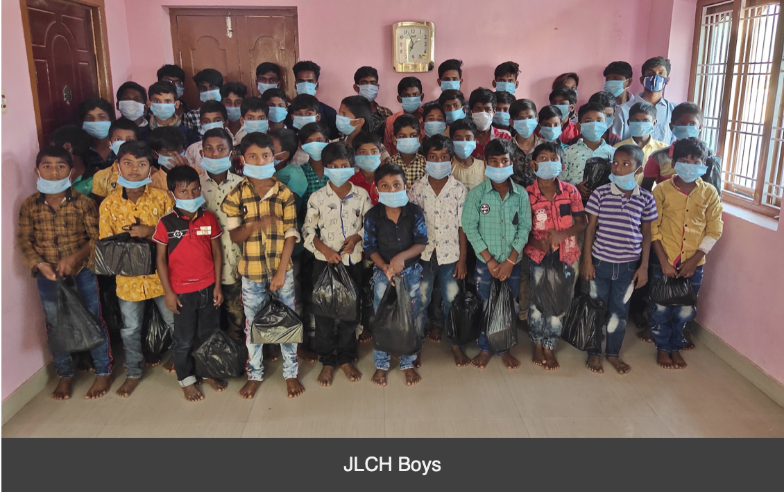 A group of children wearing face masks are posing for a picture.