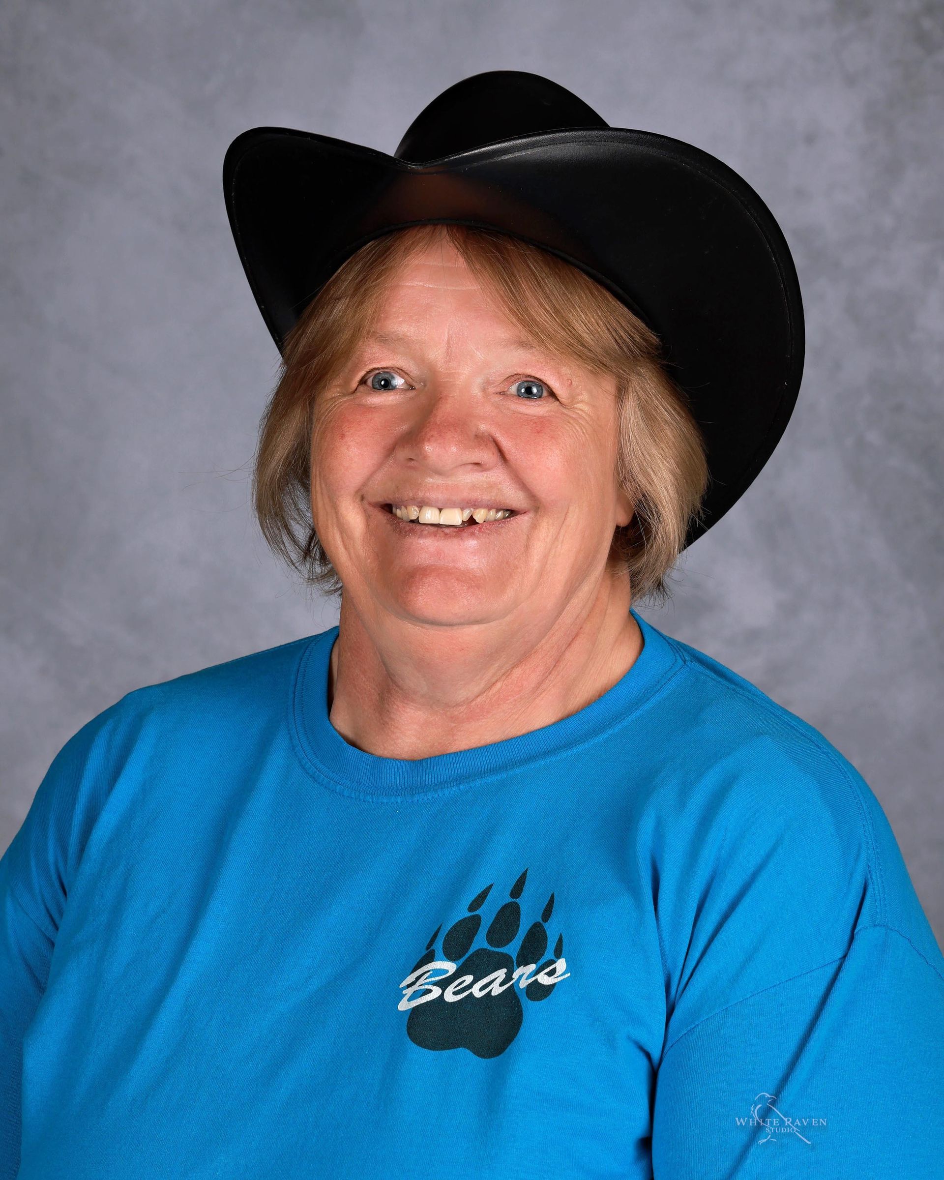 Woman wearing a black cowboy hat and blue 