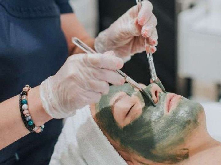 Lela applying a mask on a client during a facial treatment in Evergreen, Colorado at Lela Skin Care and Facials