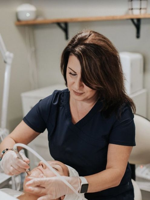 Lela completing a skincare service on a client in Evergreen, Colorado at Lela Skin Care and Facials