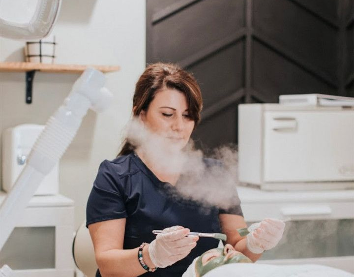 Lela steaming a clients face during a facial in Evergreen, Colorado at Lela Skin Care and Facials