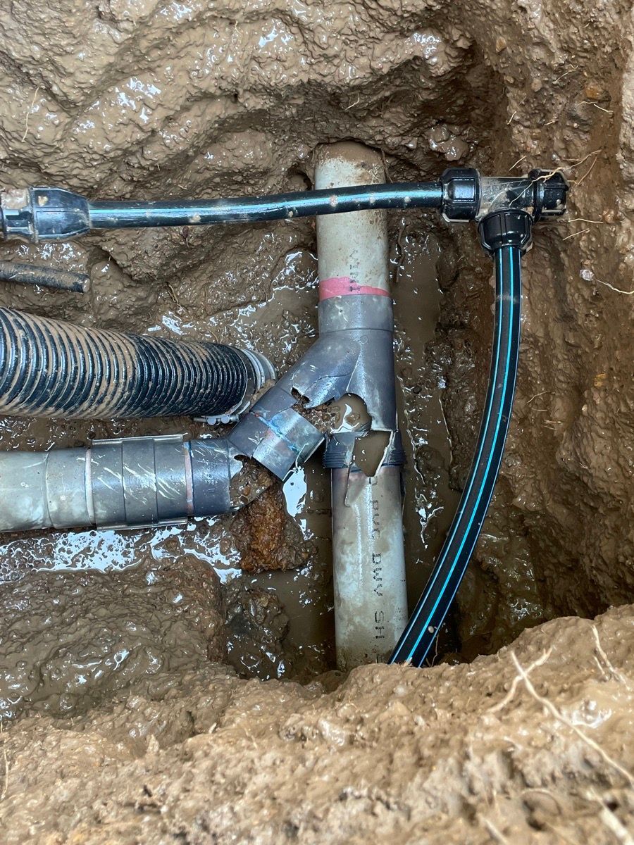 A bunch of pipes are laying in the dirt. — Wigg Plumbing in Berrimah, NT
