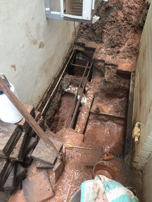 A Person is Digging a Hole in the Ground With a Shovel — Wigg Plumbing in Berrimah, NT